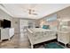 Cozy main bedroom featuring a ceiling fan, sliding glass doors, and ample natural light at 5307 1St Avenue Nw Dr, Bradenton, FL 34209