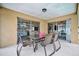 Enjoy outdoor dining on this covered patio with a table and chairs, easily accessible through sliding glass doors at 5307 1St Avenue Nw Dr, Bradenton, FL 34209