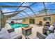 Relaxing screened-in pool area with comfortable seating and a modern fire pit at 5307 1St Avenue Nw Dr, Bradenton, FL 34209