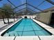 Enclosed pool with crystal-clear water, ladder entry, and seating area; perfect for relaxation and entertaining at 5307 1St Avenue Nw Dr, Bradenton, FL 34209