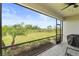 Relaxing screened patio with a clear view of the expansive backyard and landscaping at 5406 Coral Reef Way, Lakewood Ranch, FL 34211