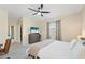 Neutral bedroom featuring a ceiling fan, television, walk-in closet, and a window at 5406 Coral Reef Way, Lakewood Ranch, FL 34211