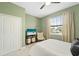Bedroom featuring a ceiling fan, closet, television, and a window at 5406 Coral Reef Way, Lakewood Ranch, FL 34211
