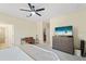 Bedroom featuring a ceiling fan, closet, ensuite bathroom, and carpeted floors at 5406 Coral Reef Way, Lakewood Ranch, FL 34211