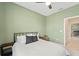 This bedroom features an inviting atmosphere with light green walls and a large comfortable bed at 5406 Coral Reef Way, Lakewood Ranch, FL 34211