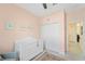 A charming Bedroom with pink walls, a white crib, and decorative floral artwork at 5406 Coral Reef Way, Lakewood Ranch, FL 34211