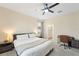 Comfortable bedroom featuring an ensuite bathroom, desk, and ceiling fan at 5406 Coral Reef Way, Lakewood Ranch, FL 34211