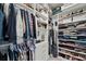 Spacious walk-in closet with custom shelving for clothes and shoes at 5406 Coral Reef Way, Lakewood Ranch, FL 34211