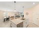 Open concept kitchen and living area featuring granite counters, stainless appliances, and tile flooring at 5406 Coral Reef Way, Lakewood Ranch, FL 34211