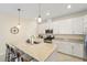 Well-lit kitchen features stainless steel appliances, granite countertops, and an island with bar seating at 5406 Coral Reef Way, Lakewood Ranch, FL 34211
