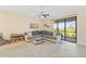Comfortable living area with a large sectional sofa and sliding glass doors at 5406 Coral Reef Way, Lakewood Ranch, FL 34211