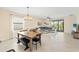 Open-concept living and dining area with large windows and tile flooring at 5406 Coral Reef Way, Lakewood Ranch, FL 34211
