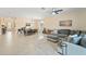 Bright open-concept living area featuring tile floors, a ceiling fan, and an adjacent dining area at 5406 Coral Reef Way, Lakewood Ranch, FL 34211