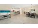 Bright, open-concept living space with modern kitchen, dining area, and large television for entertaining at 5406 Coral Reef Way, Lakewood Ranch, FL 34211