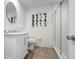 Bathroom featuring a stylish vanity, a large mirror and tiled shower with glass door at 5523 Scotia Pl, Sarasota, FL 34231