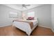 Cozy bedroom featuring wood floors, natural light, and a comfortable queen bed at 5523 Scotia Pl, Sarasota, FL 34231