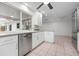 Modern kitchen featuring stainless steel appliances, white cabinets, and granite countertops at 5523 Scotia Pl, Sarasota, FL 34231