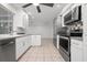 Modern kitchen with stainless steel appliances, white cabinets and granite countertops at 5523 Scotia Pl, Sarasota, FL 34231