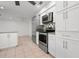 Modern kitchen with stainless steel appliances, white cabinets and granite countertops at 5523 Scotia Pl, Sarasota, FL 34231