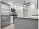 Modern kitchen featuring stainless steel appliances, white cabinets, and granite countertops at 5523 Scotia Pl, Sarasota, FL 34231