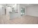 Bright living room with tile floors and sliding glass doors to the pool area at 5523 Scotia Pl, Sarasota, FL 34231