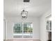 An empty room with tile floors leading to sliding glass doors with a pool view at 5523 Scotia Pl, Sarasota, FL 34231