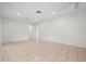 Spacious living room with neutral tile flooring and a ceiling fan at 5523 Scotia Pl, Sarasota, FL 34231