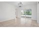 An empty room with tile floors leading to sliding glass doors with a pool view at 5523 Scotia Pl, Sarasota, FL 34231