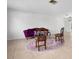 Open-concept living room with neutral tile flooring, vintage furniture, and ample natural light, ideal for entertaining at 5523 Scotia Pl, Sarasota, FL 34231