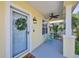 View of front door and front porch with a seating area and potted plants at 5532 River Sound Ter, Bradenton, FL 34208