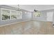 Bright living room with tile floors, a chandelier, and lots of natural light at 5532 River Sound Ter, Bradenton, FL 34208
