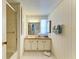 Well-lit bathroom featuring a vanity with storage, a mirror, and a shower with glass doors at 5619 Bayshore Rd # 152, Palmetto, FL 34221