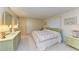 Inviting bedroom with floral bedspread, light wood walls, a window, and a dresser with a lamp at 5619 Bayshore Rd # 152, Palmetto, FL 34221
