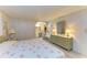 Cozy bedroom featuring a floral bedspread, dresser with lamps, and an arched opening to the bathroom at 5619 Bayshore Rd # 152, Palmetto, FL 34221