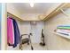 Spacious walk-in closet with shelving, clothes, walker, and vacuum cleaner for convenient organization at 5619 Bayshore Rd # 152, Palmetto, FL 34221