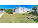 View of the side yard of a single story home with landscaped yard at 5619 Bayshore Rd # 152, Palmetto, FL 34221