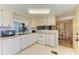 Efficient kitchen space with white appliances and view into dining room at 5619 Bayshore Rd # 152, Palmetto, FL 34221