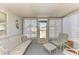 A sunroom featuring lots of windows, light-colored furniture, and a door leading outside at 5619 Bayshore Rd # 152, Palmetto, FL 34221