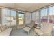 Bright sunroom with lots of windows, furniture, and a door leading to the outside at 5619 Bayshore Rd # 152, Palmetto, FL 34221