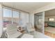 Enclosed sunroom provides a cozy spot with its comfortable seating and natural light from large windows at 5619 Bayshore Rd # 152, Palmetto, FL 34221