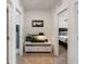 Hallway featuring a fish tank, storage bench, neutral paint, and doorways leading to adjacent rooms at 5868 Calla Lilly Dr, Sarasota, FL 34232