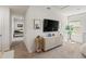 Bright living room boasts neutral tones, plush carpeting, and a large window for natural light, creating a cozy ambiance at 5868 Calla Lilly Dr, Sarasota, FL 34232