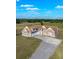 Aerial view of the home with a long driveway, 3-car garage, and surrounding acreage at 5949 225Th E St, Bradenton, FL 34211