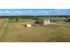 Aerial view of the property showing home, outbuildings, and surrounding expansive acreage at 5949 225Th E St, Bradenton, FL 34211