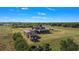 Aerial view of estate, featuring home, barn, enclosed pool, outbuildings, and sprawling land at 5949 225Th E St, Bradenton, FL 34211