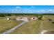 Spacious property featuring a home, barn, and extensive land with blue skies and scattered clouds at 5949 225Th E St, Bradenton, FL 34211