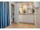Bright bathroom featuring white cabinets, dual sinks, a vanity, and tile flooring at 5949 225Th E St, Bradenton, FL 34211