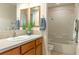 Bathroom with wooden cabinets, dual mirrors and a tub-shower combination at 5949 225Th E St, Bradenton, FL 34211