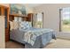 Bright bedroom with an ocean-themed decor, comfortable bed, and natural light from the window at 5949 225Th E St, Bradenton, FL 34211