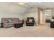 A versatile bonus room featuring a couch and an armchair with an open doorway at 5949 225Th E St, Bradenton, FL 34211